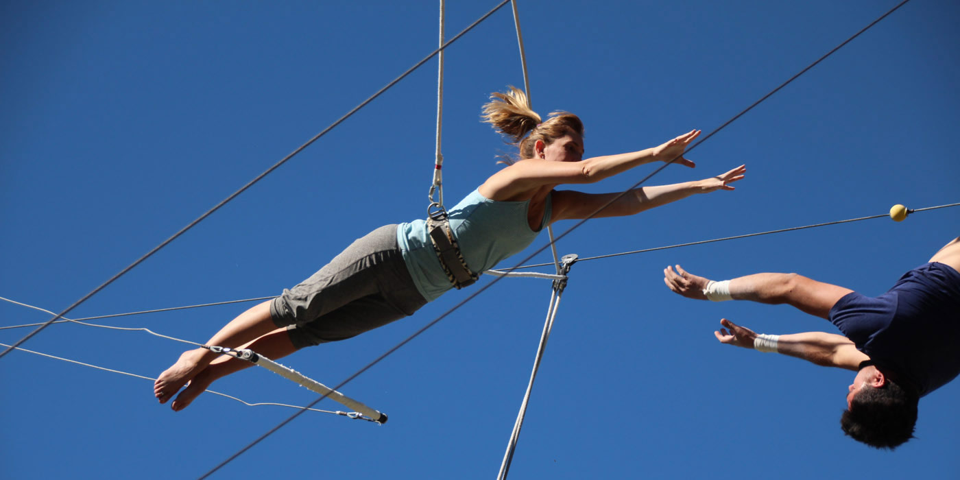 Woman flying on trapeze